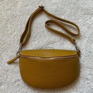 Adjustable strap mustard colored leather bum or cross-body bag.
